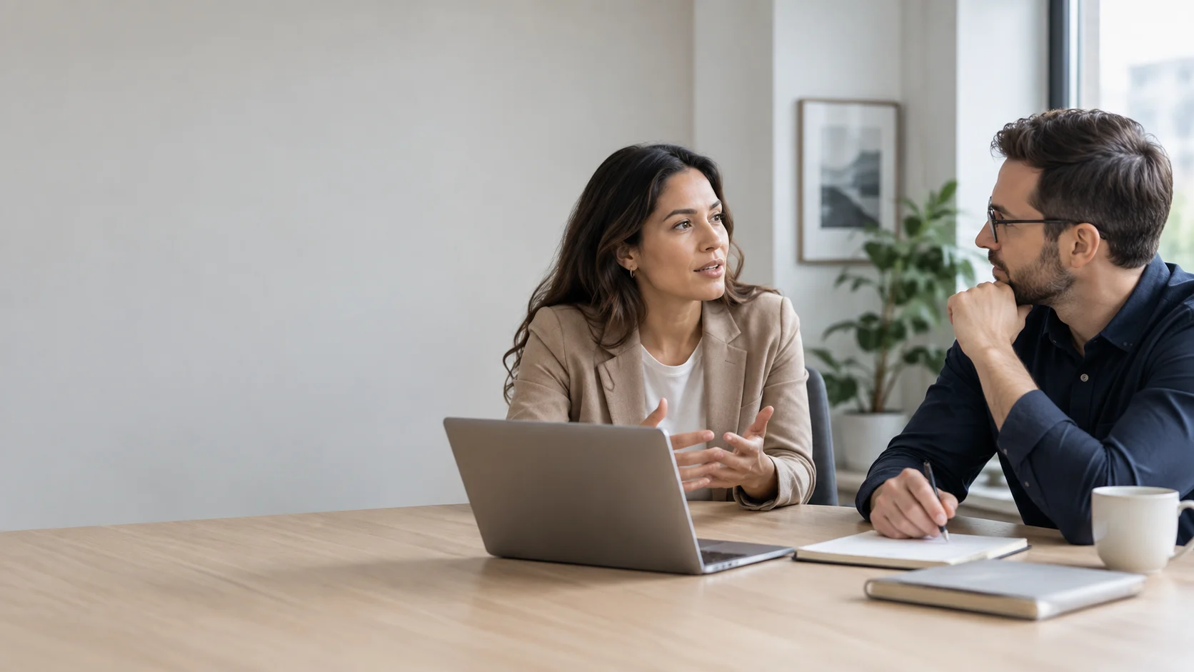 Two professionals discussing different viewpoints during a calm office meeting.